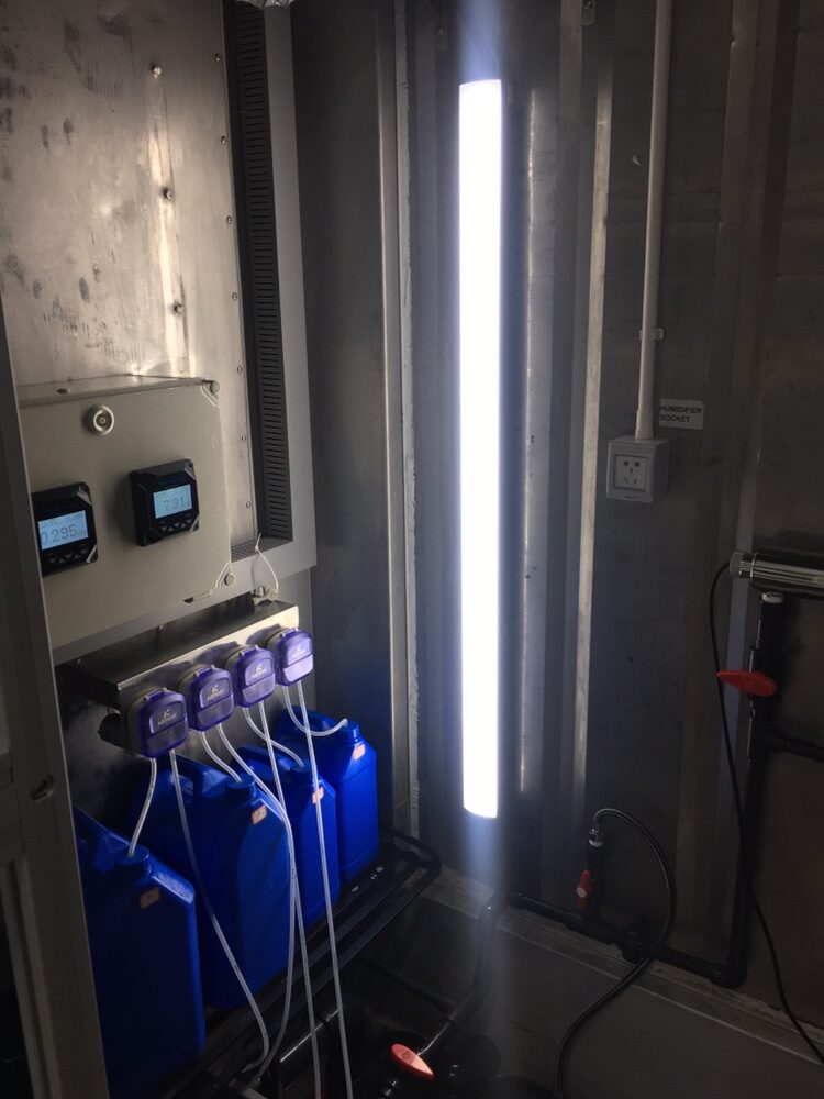 Dosing bay with pH and EC readouts, four peristaltic dosing pumps and nutrient jugs below